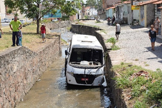 Motorista desvia micro-ônibus para evitar colisão com moto, mas bate em carro e cai em canal em Feira de Santana