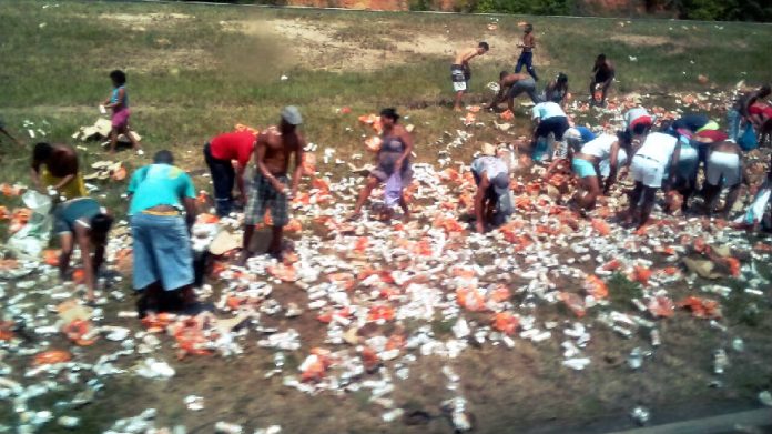 Carreta carregada de cerveja em lata tomba na Bahia e carga é saqueada em minutos